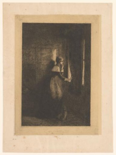 Young woman looking out through a curtain