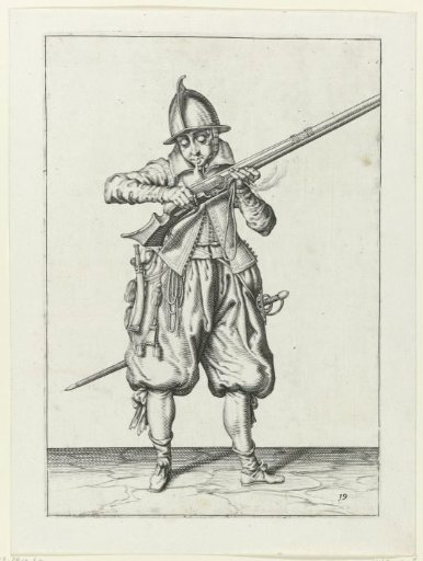 Soldier blowing powder from his musket