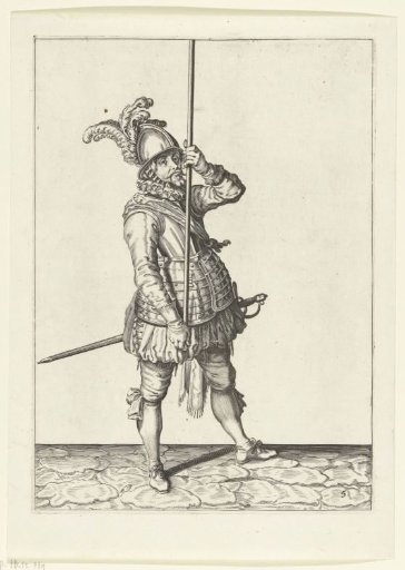 Soldier holding his spear upright with both hands high above the ground in front of him