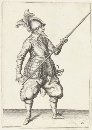 Soldier carrying his spear with his left hand at his right side, the point angled upwards