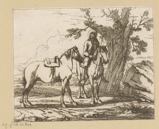 Rider holding another saddled horse by the reins