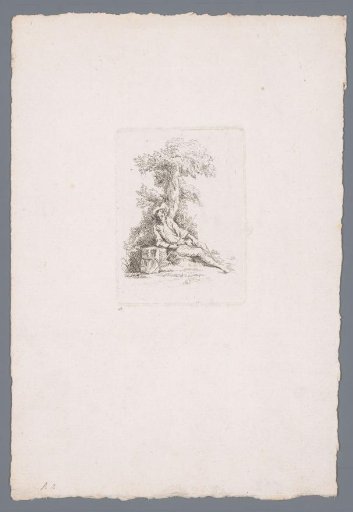 Young man resting by a tree