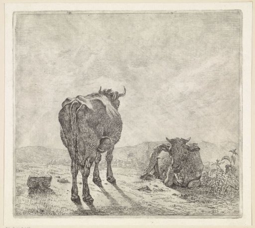 Two cows and a village in the background