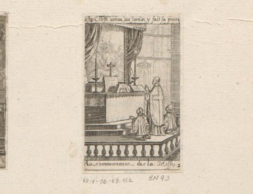Priest with two boys praying at an altar at the beginning of the Mass