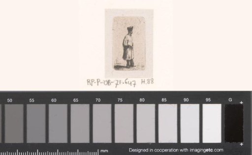 Standing man with high cap and arms behind his back