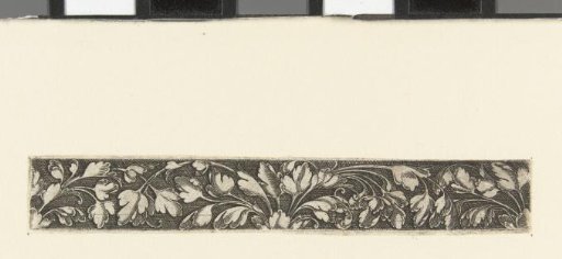 Leaf scrolls, sprouting from leaves in the center and at both ends of the frieze