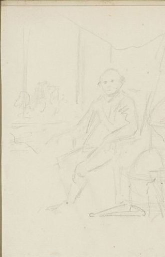 Interior with a man sitting next to two globes