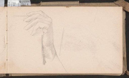 Hand holding a leaf or book