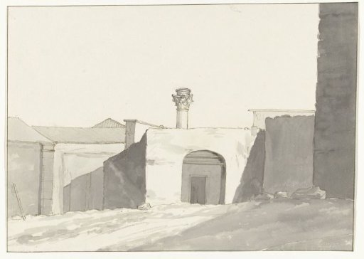 Ancient column and buildings in the harbor of Brindisi