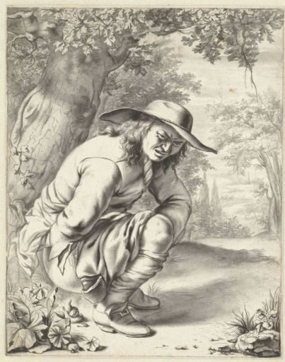 A man relieving himself while crouching by a tree
