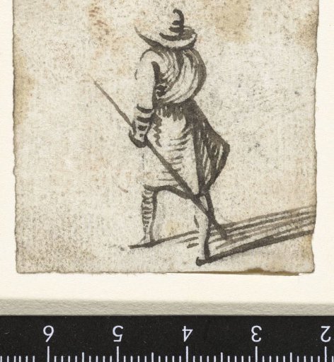 Man with a broad-brimmed hat and a stick in his hand, from behind