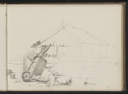 Tipped-over handcart in front of a farmhouse