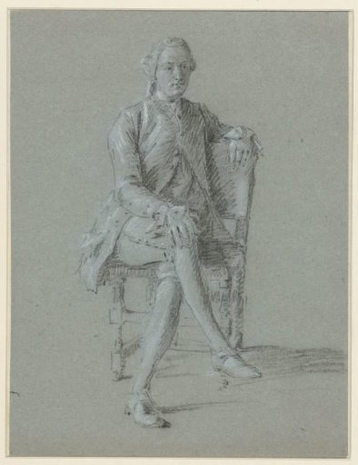 Man seated on a chair with legs crossed