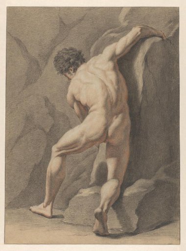 Kneeling male nude by a rock