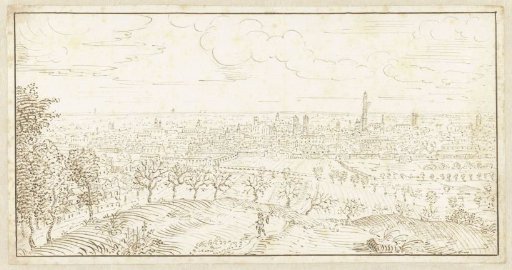 View from a hill over a row of trees towards a town