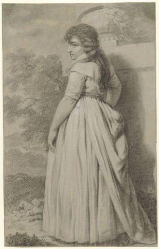 Young woman, seen from the back, standing in a garden