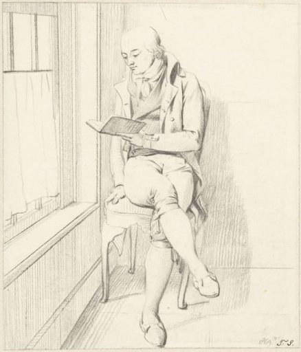 Seated man reading by a window