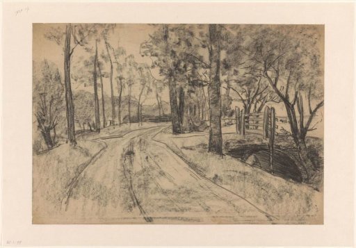 Path between trees, to the right a bridge with a fence