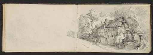 Half-timbered house among the trees at the foot of a mountain