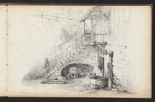 Courtyard with a staircase to a balcony at the rear of a house