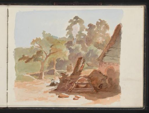 Pile of wood in front of a hut