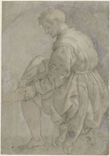 Seated man putting on his stocking