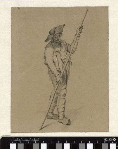 Standing boy with a long staff