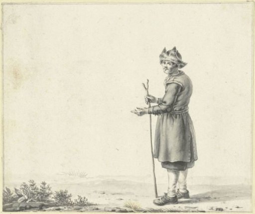 Standing man with fur cap and staff