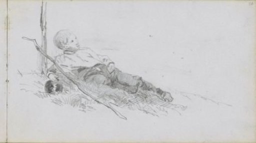 Boy lying in the grass with a stick and a jug