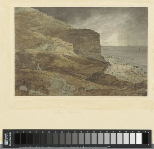 Rocky seashore with a resting man