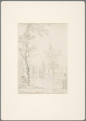 Seated man next to a tree by the water
