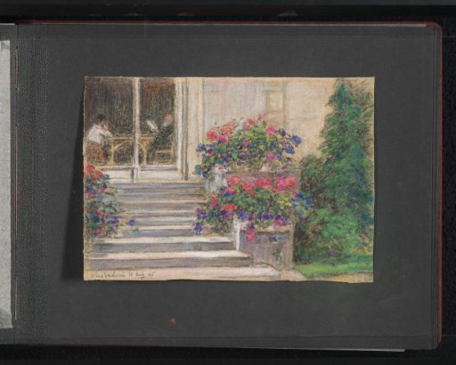 Staircase with flower boxes leading to a building, with two people at a table inside, at Wiesbaden