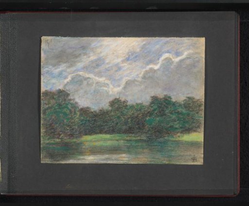 Cloudy sky above a park with a pond