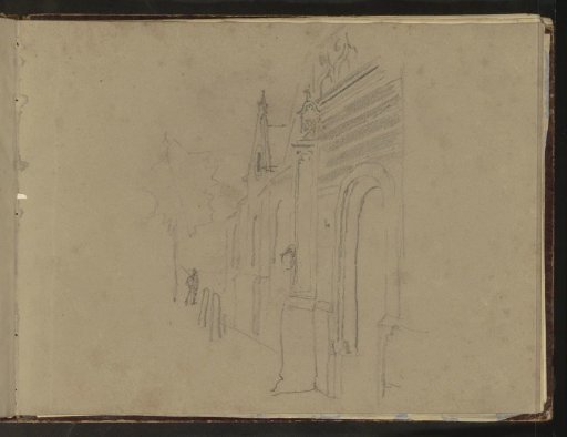 Man on a street with a gate
