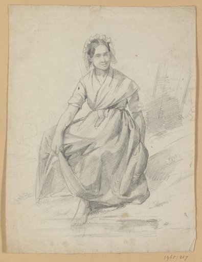 Seated woman on a bank, with one foot in the water
