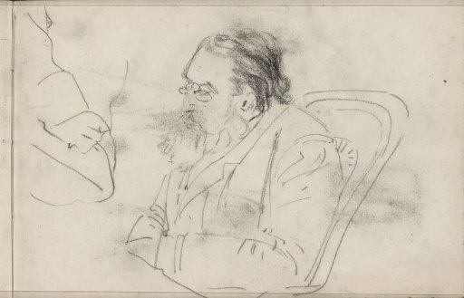 Man with a beard sitting in a chair