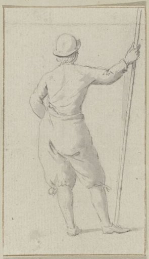 Standing man with a staff on his back, seen from behind