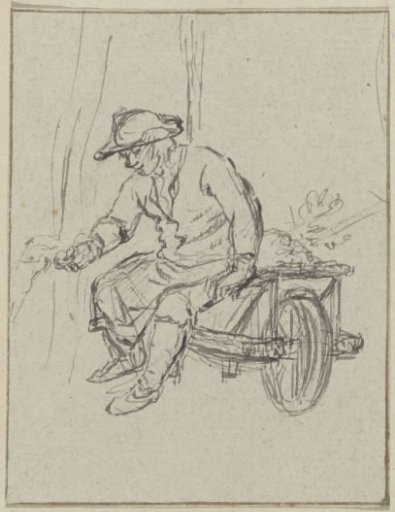 Man with hat sitting on a wheelbarrow