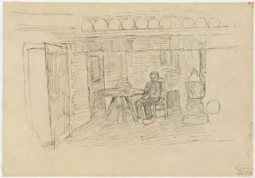 Interior with a boy sitting at a table