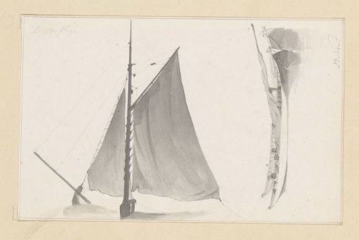 Sail of a boat and two lying boats