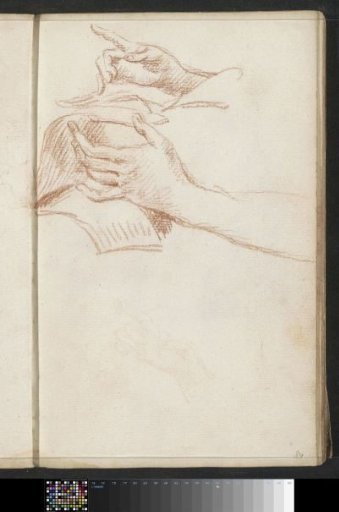 Two hands turning pages of books
