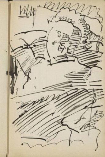 Man seated with his hand behind his head
