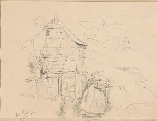 Half-timbered house by a road in a hilly landscape
