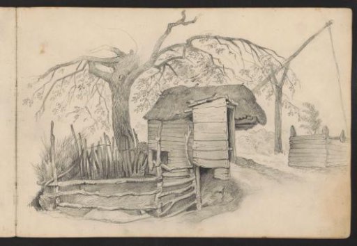 Stable with a fence by a tree
