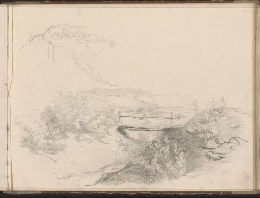 Hilly landscape with a wooden bridge over a waterway