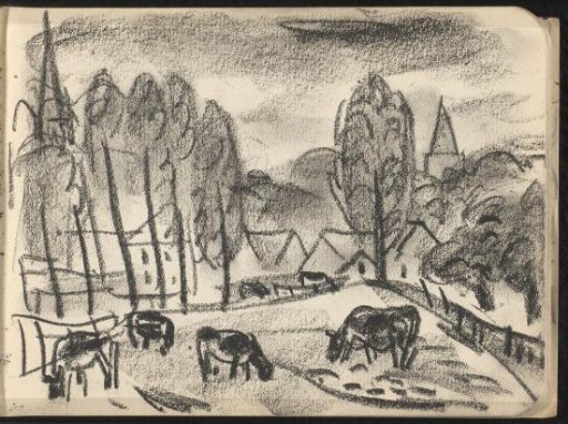 Grazing cows near a village