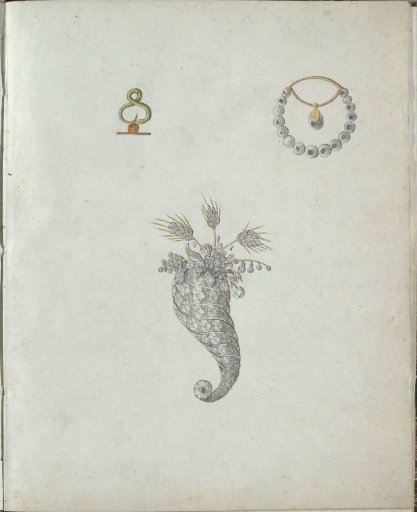 Three pieces of jewelry, one with a snake and an orange