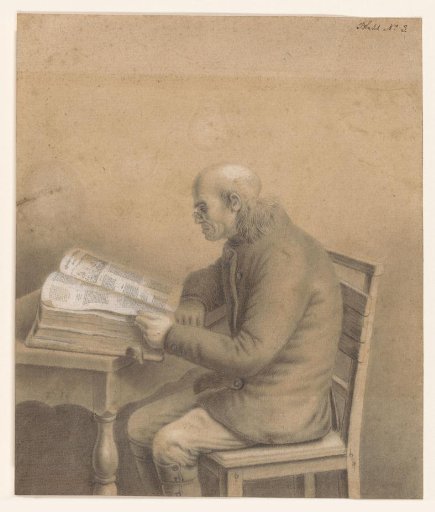 Reading old man at a table