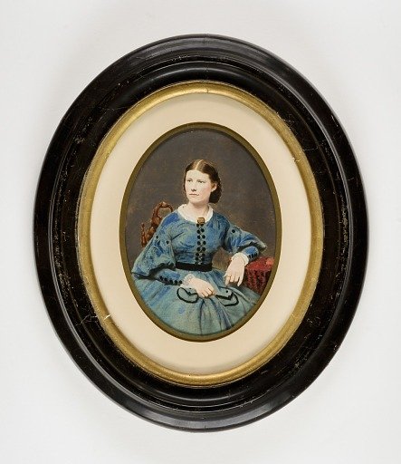 Seated Woman in Blue Dress with Black Trim