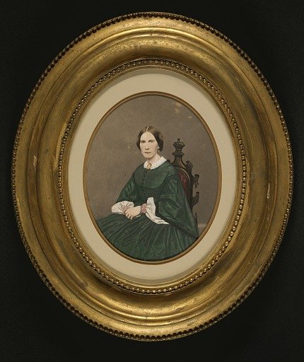 Woman in Green Dress Seated in Gothic Chair